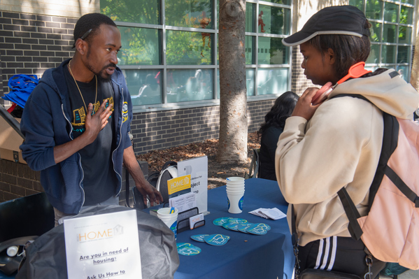 Students in WEALTH•NESS tabling a club fair 