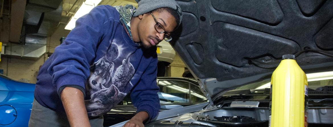 Student in Automotive Program working on a car in CCP garage. 