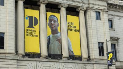 "Rise from Within" banners hanging from the College's Mint Building