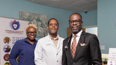 Three medical professionals posed in a doctor's office.