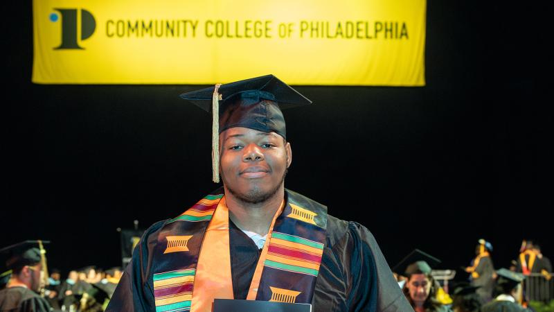 David Emdin  Holding his diploma, in a cap and gown