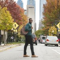 Student on 17th street, main campus, in the fall. 