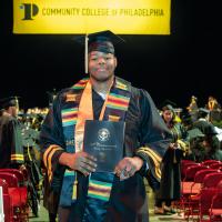 David Emdin  Holding his diploma, in a cap and gown