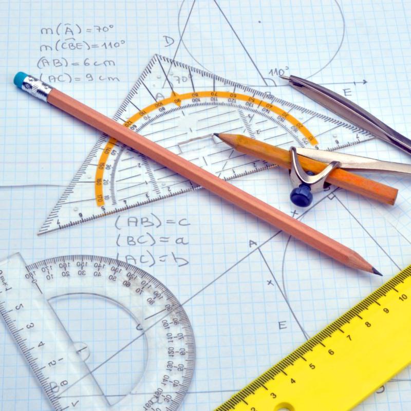 Image of pencils, pen, rulers and a grid with equations.