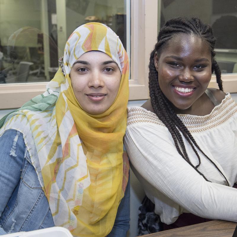 two students smiling at the camera