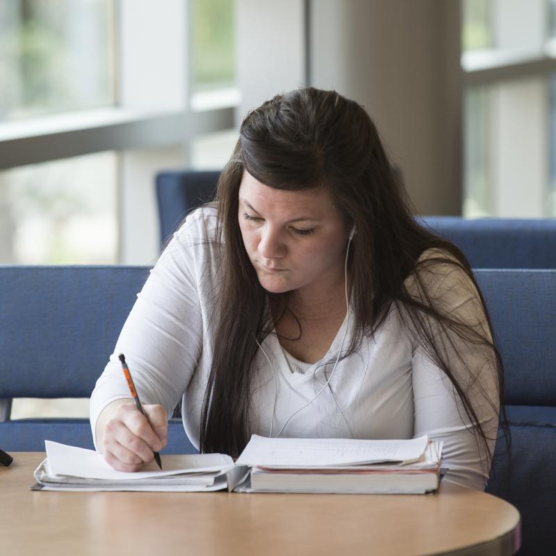 Woman sitting at a table writing