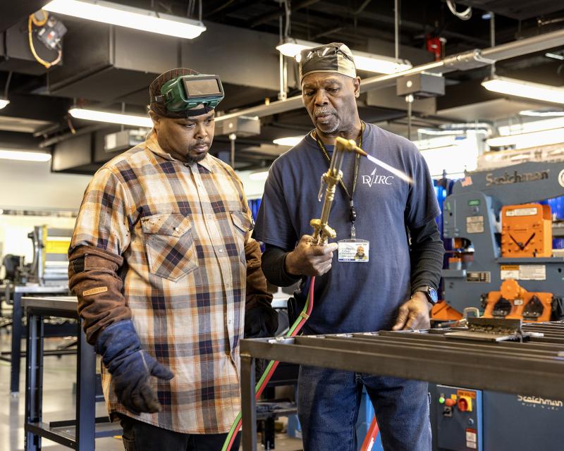 Student welding with instructor