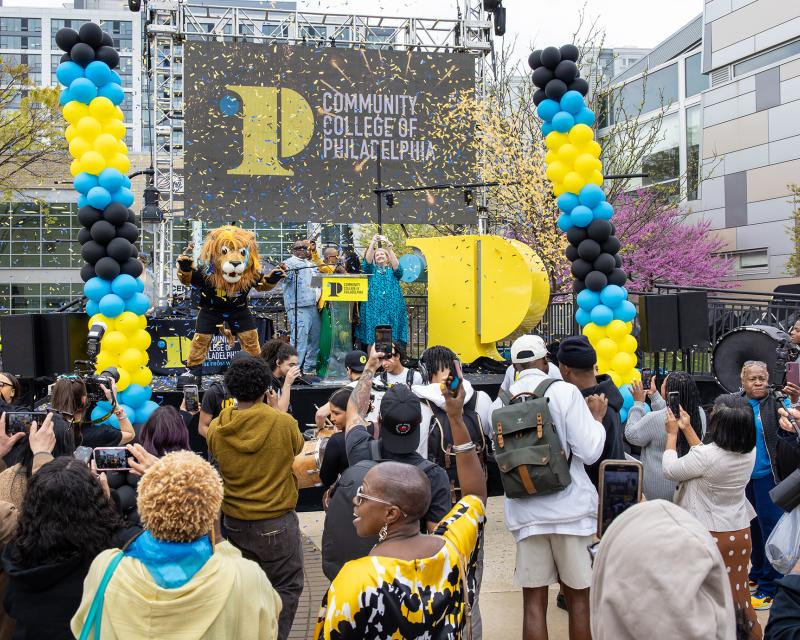 Students and Faculty around a stage and an event with confetti