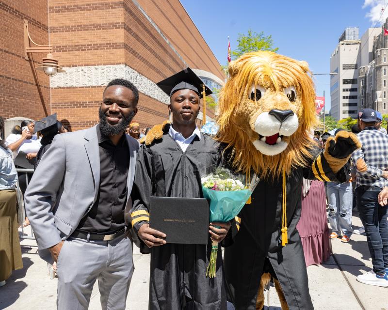 students at commencement with Roary