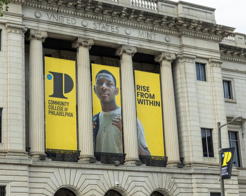 "Rise from Within" banners hanging from the College's Mint Building