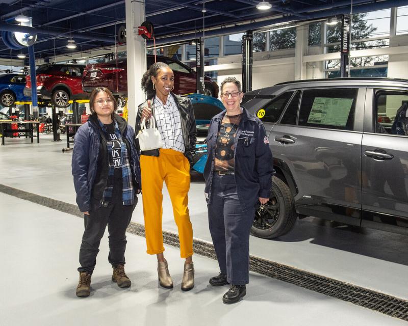 women automotive technicians standing in an automotive bay
