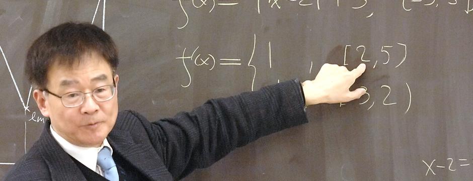 Professor teaching mathematics on chalkboard at Community College of Philadelphia.